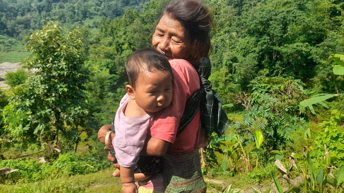 A grandmother holding a child in one of the affected communities